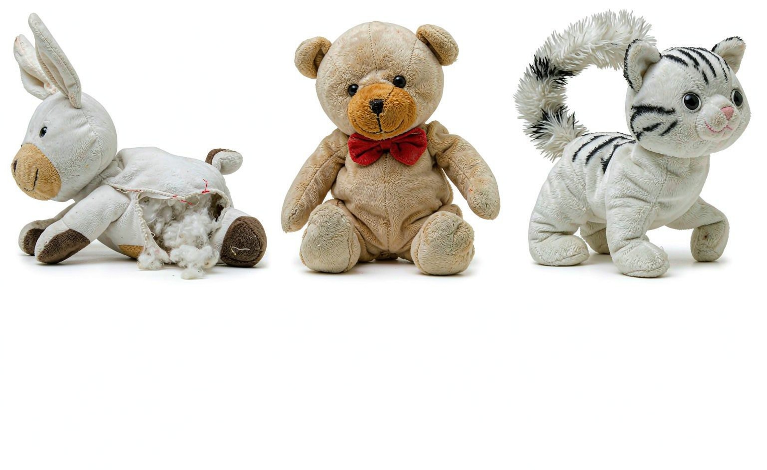 Close-up comparison of common plush toy defects: seam gap, uneven filling, loose safety eye