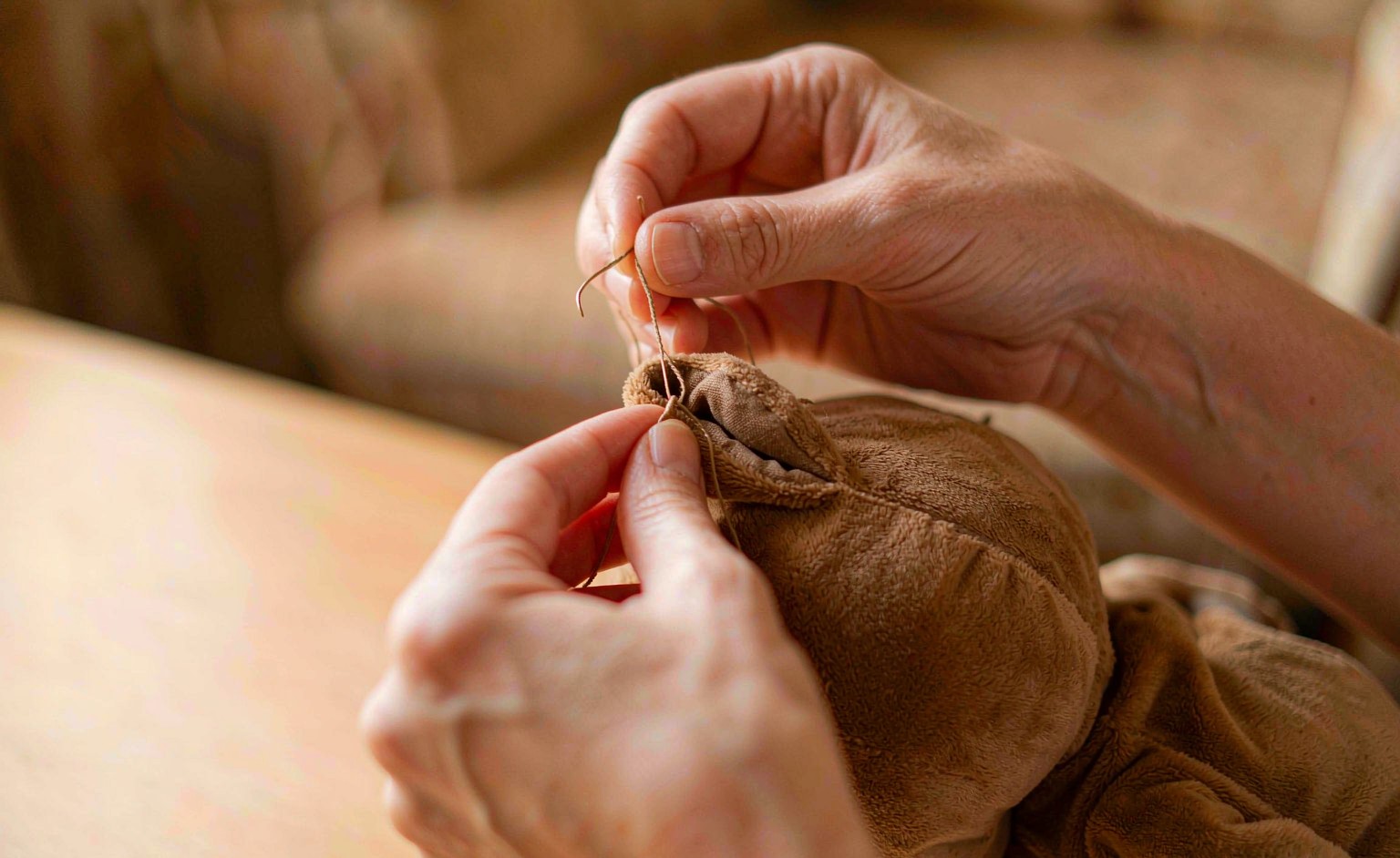 Close-up of a ladder stitch closing an open seam on a plush toy