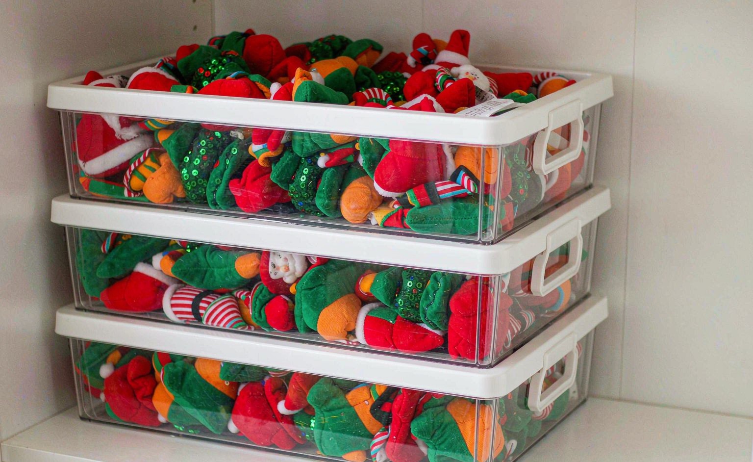 Seasonal plush toys packed in labelled clear storage bins with desiccant sachets